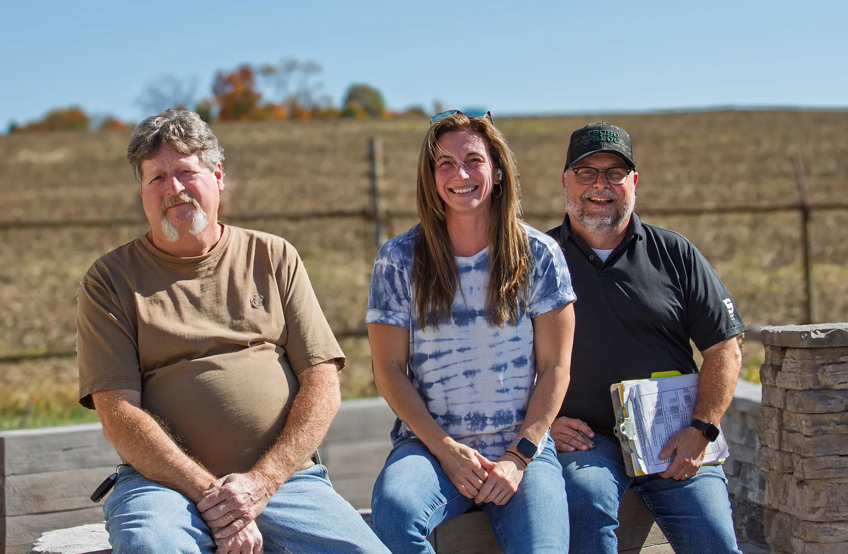 Newline Hardscapes staff sitting together on a bench. Featured in the careers section.