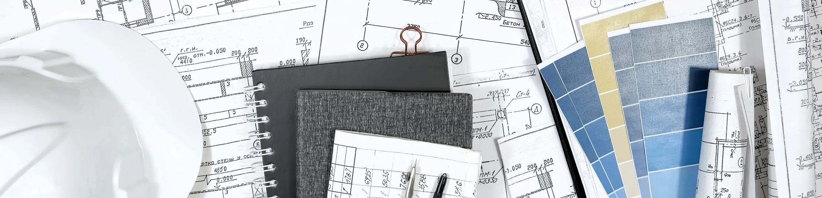 A hard hat, notebooks, various color swatches, and blueprints. Featured in the product data sheets section of the resources page.