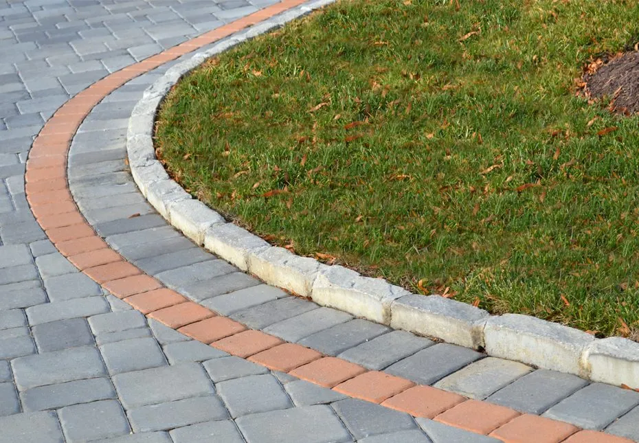 An Edgestone™ border in Covington color edging a walkway, featured in the Edgestone product section.