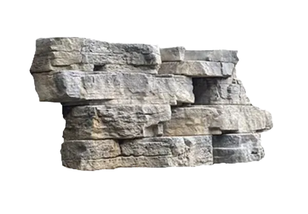 A wall of stacked, weathered gray rocks that are featured in the Outcropping™ Wall section of products.