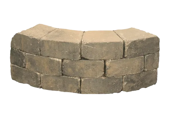 A curved Ashland™ segmental retaining wall with chiseled texture, featured in the Walls section of Newline Hardscapes.